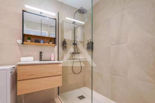 a bathroom with a shower with a sink and a mirror at New Large Studio - Monaco Border - Sea View - Lift - Parking included in Beausoleil
