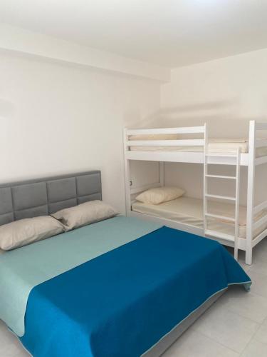 a bedroom with a bed and a bunk bed at BlueWaveapartments 4 in Shëngjin