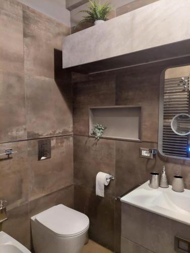a bathroom with a toilet and a sink at DaSimo in Lido di Fermo