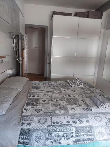 a bedroom with a bed with a quilt on it at DaSimo in Lido di Fermo