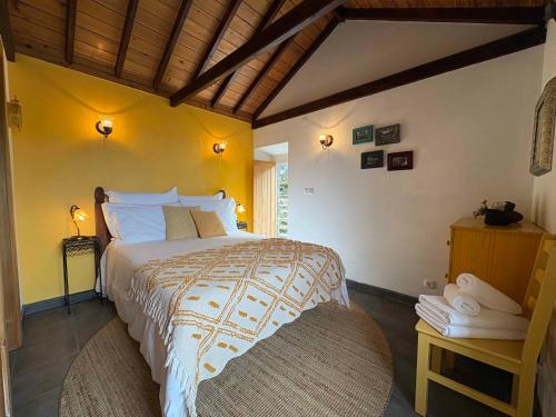 a bedroom with a large bed in a room at Casa do Laureano in Santo Amaro