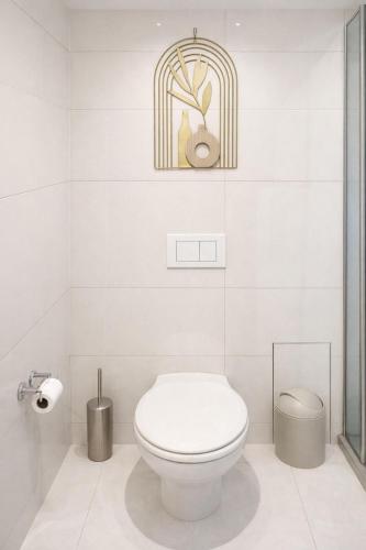 a white bathroom with a toilet and a mirror at Jubilee Stay in Windhoek