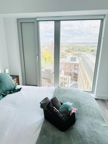 a bedroom with a white bed with a large window at Stylish Modern 1-Bed Apartment in Manchester