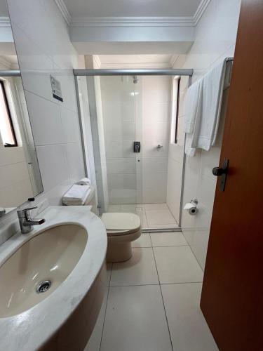 a bathroom with a sink and a toilet and a shower at Aquarius Flat 510 in Santa Cruz do Sul