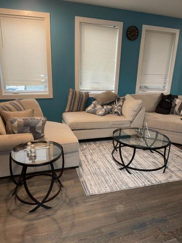 a living room with two tables and a couch at Temperly Heavon in Newark