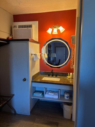a bathroom with a sink and a mirror at Viking Motel in Lindsborg