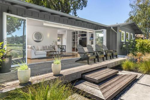 a wooden deck with chairs and a couch on it at Haven With Pool, Hot Tub And Tastings Included in Healdsburg