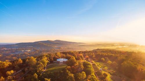 an aerial view of a house on a hill with trees at Monticello Inn & Cottage in Scottsville