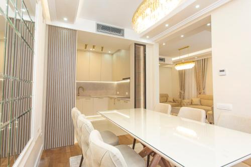a dining room with a white table and chairs at Apartment Harmonia in Dobrota