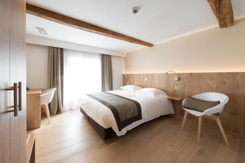 Posteľ alebo postele v izbe v ubytovaní Hotel Le Fournil