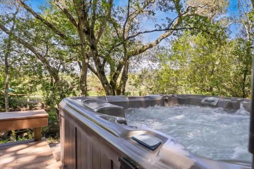 a hot tub in a backyard with trees at Bennett Valley Eden in Santa Rosa