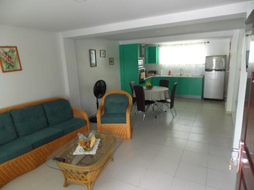 a living room with a couch and a table at At Rachel in Paramaribo