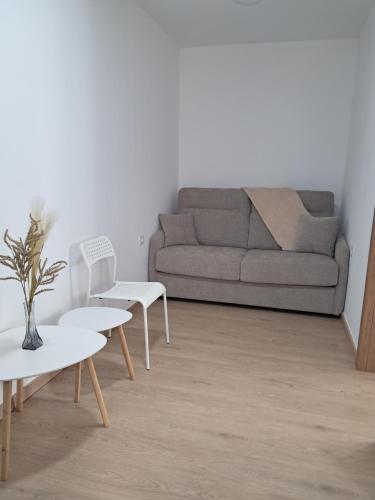 a living room with a couch and a table at Andrea's house in Charco del Pino
