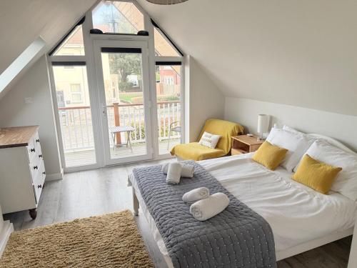 a bedroom with a bed with two pillows on it at Gig Lodge Perfect Swanage Base in Swanage