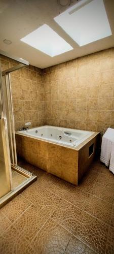 a bathroom with a large tub in a room at La Huerta golf & hotel in Cholula