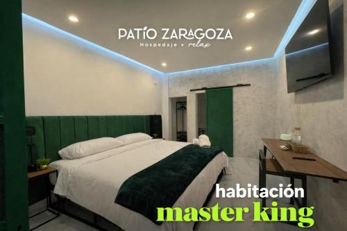 a hotel room with a bed and a television at Hotel PATIO ZARAGOZA, Centro Histórico SLP in San Luis Potosí
