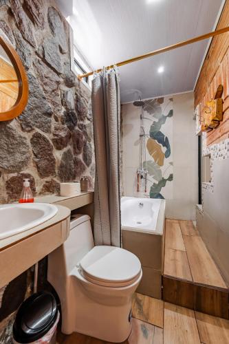 a bathroom with a toilet and a sink at Watzara Wasi Studios en Cotacachi in Cotacachi