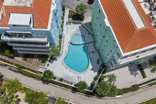 an overhead view of a swimming pool at a resort at Spacious Ocean View Apartments with Balcony in Blue Bay in Blue Bay