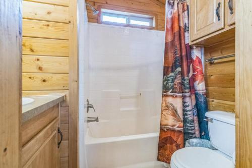 a bathroom with a toilet and a shower curtain at Durango RV Resort in Durango