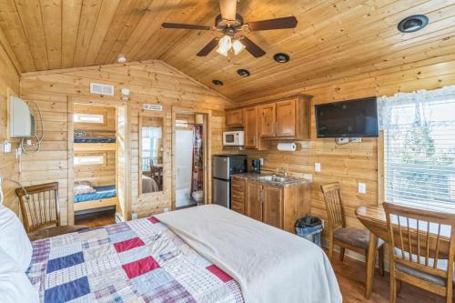 a bedroom with a bed in a wooden cabin at Durango RV Resort in Durango