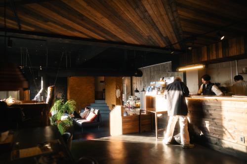 a man standing at a counter in a restaurant at RoheN ASHINOKO in Hakone