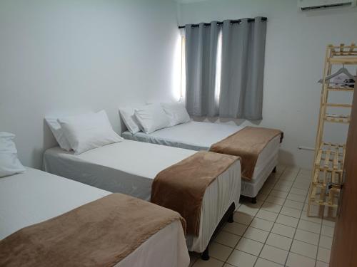 a room with three beds and a ladder at Family Beach flat - frente ao mar in Barra de São Miguel