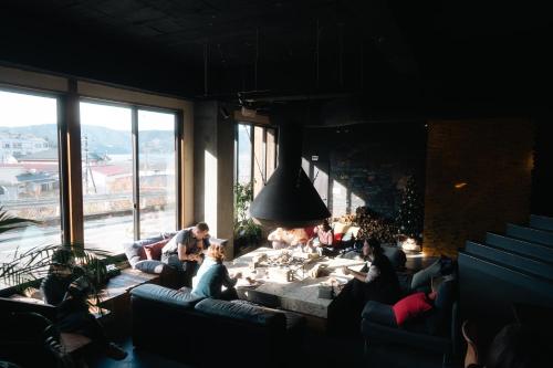 a group of people sitting in a living room at RoheN ASHINOKO in Hakone