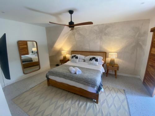 a bedroom with a large bed and a mirror at Villa Alam in Nusa Lembongan
