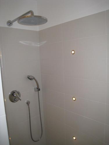a bathroom with a shower with a shower head at Studio magnifique vue mer in Menton