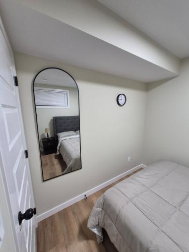 a bedroom with a bed and a mirror at Clear Edge Suites in Saskatoon