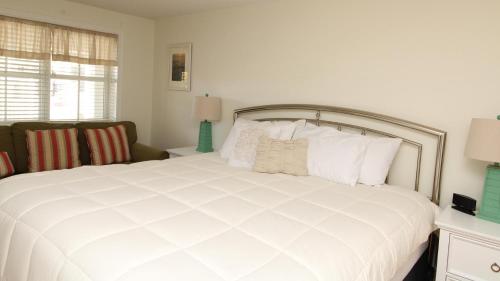 a bedroom with a large white bed with white pillows at Condo At The Cove Unit 5 in Cape May