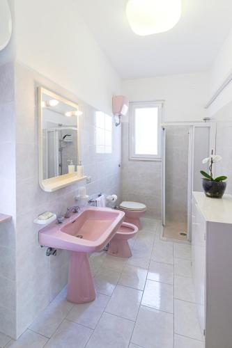 a bathroom with a pink sink and a toilet at Rosa di Ischia - Holiday in Ischia Town