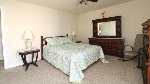 a bedroom with a bed and a dresser and a mirror at 215 Heritage Lane in Cape May