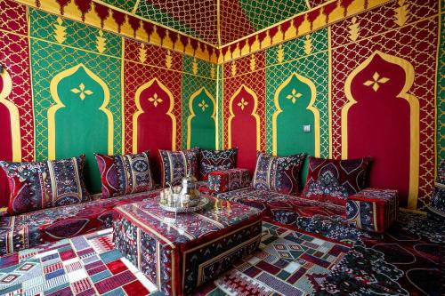 a living room with a couch and colorful walls at Villa America Dakhla in Dakhla