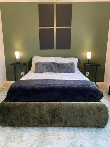 a bedroom with a large bed with two night stands at LE 710 Maison d'invitée in Saint-Georges