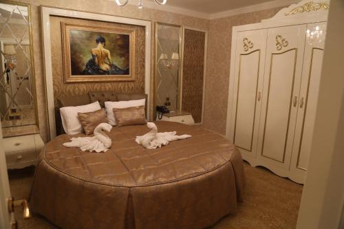 a bedroom with a bed with two swans on it at Vivaldi Park Hotel in Ankara