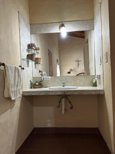 a bathroom with a sink and a large mirror at Casa Tafi del Valle in Tafí del Valle