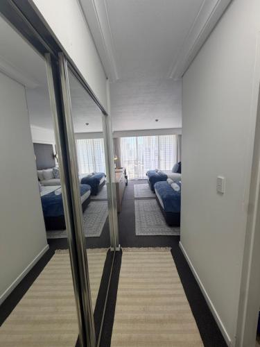 a room with two beds and a mirror at Oceans 11 in Gold Coast