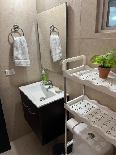 a bathroom with a sink and a mirror and a toilet at Beach House in Coronado in Nueva Gorgona