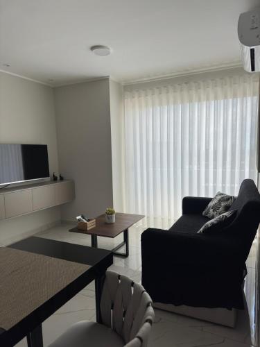 a living room with a couch and a television at Serenity Loft - Confort, Relax y Buena Ubicación in Santa Cruz de la Sierra