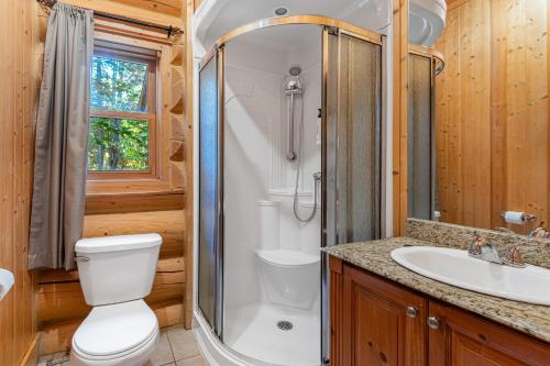 a bathroom with a shower and a toilet and a sink at Fiddler Lake Resort - Rabbit 12 in Mille-Isles
