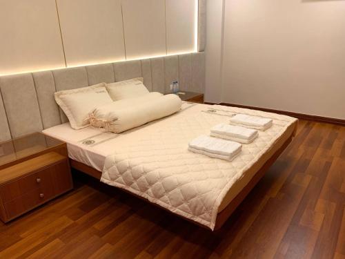 a bedroom with a bed with two towels on it at Modern Condo in Phnom Penh ByDN in Phnom Penh