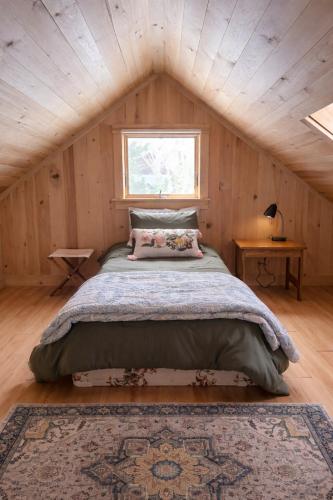 a bedroom with a large bed in a attic at Cozy Coastal Hideaway with Harbor Views in Tremont