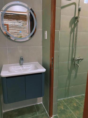 a bathroom with a sink and a mirror and a shower at Góc Núi Homestay in Thôn Dư Khánh