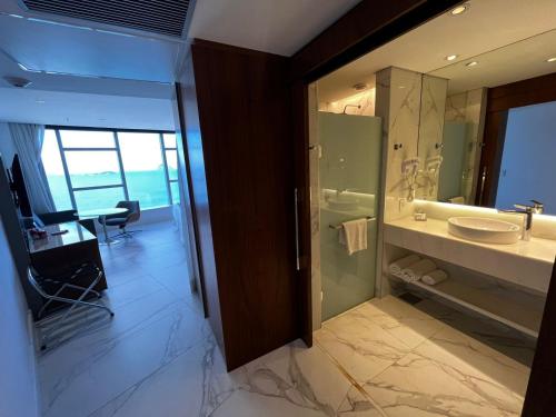 a bathroom with a shower and a sink and a mirror at Hotel Nacional in Rio de Janeiro