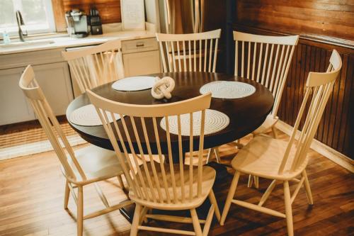 a black dining room table and chairs in a kitchen at Corton Lodge Bell Tower Suite Private Riverfront in Clendenin