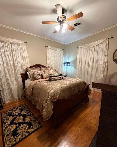 a bedroom with a bed with a ceiling fan at Opus House Historic Natchitoches in Natchitoches