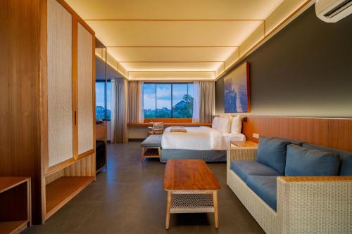 a hotel room with a bed and a couch at The Line Villas Canggu in Canggu