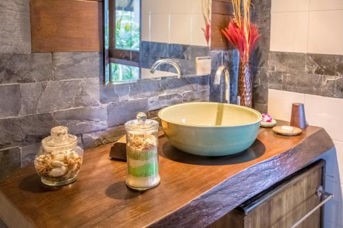 a kitchen counter with a bowl and a sink at Beyond The Blue Horizon Boutique Bungalows in Haad Chao Phao