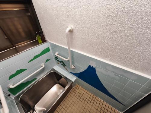 a bathroom with a sink in a public restroom at 4 minute walk from the station,USJ33min KIX48min Namba10min, Convenience store, coin laundry, public bath, all 1 minute walk Kitakagaya INN OSAKA , 6 ppl, Near Namba to 10min,駅近徒歩4分一軒家貸切北加賀屋駅からなんば駅まで10分 in Osaka